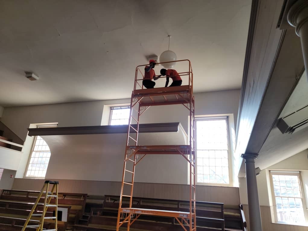 replacing light bulbs at Historic Church with scoffing
