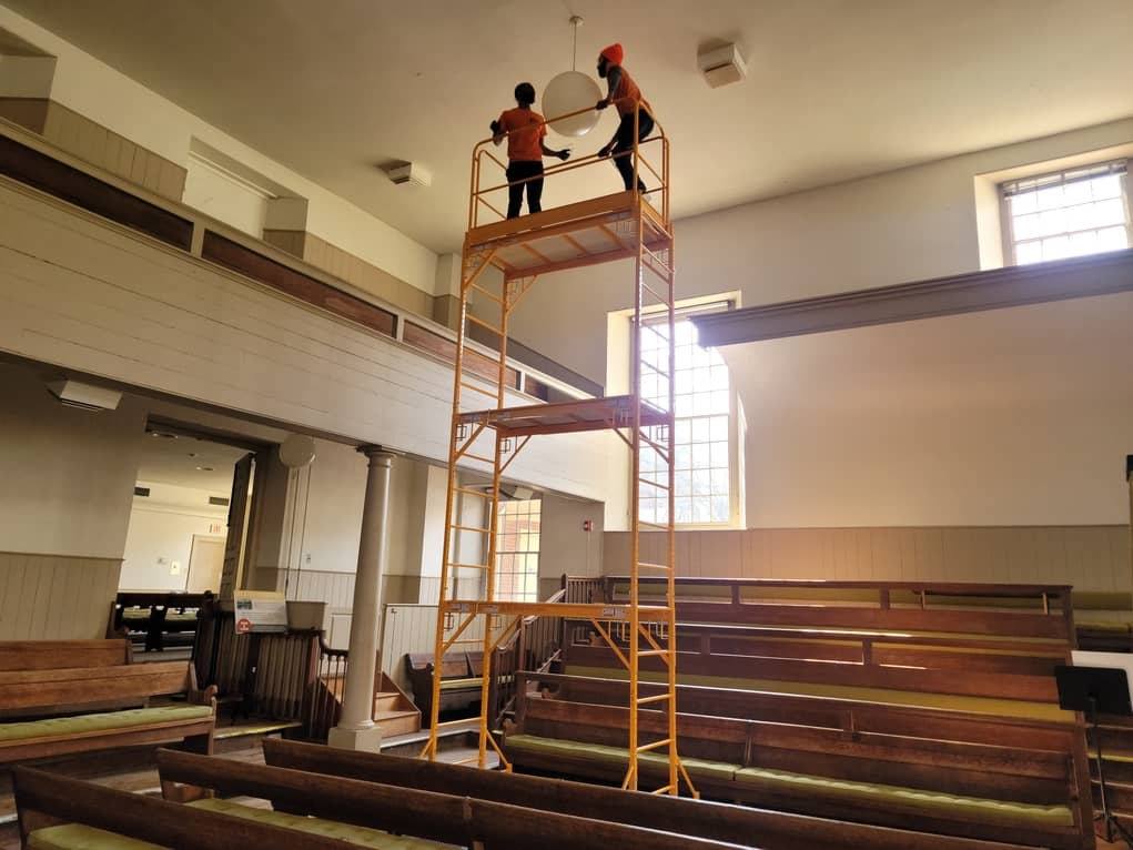 replacing light bulbs at Historic Church with scoffing